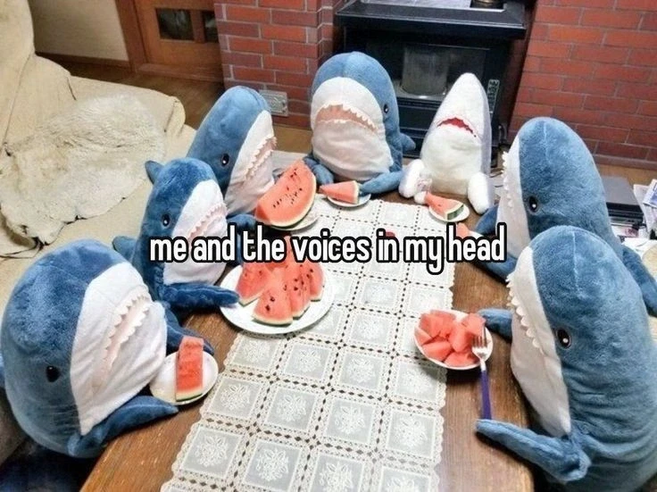 Picture of a bunch of Blåhajs sitting around a table eating watermelon captioned: "me and the voices in my head"