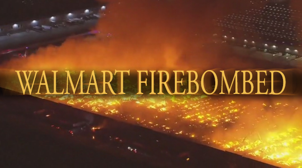 A picture of the Kimberly-Clark Warehouse in Ontario, California burning to the ground, with a Dark Souls 3 esque caption over it saying WALMART FIREBOMBED